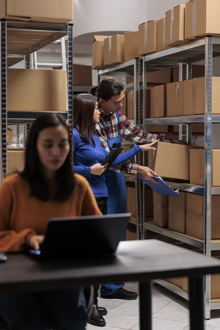 Postal storehouse employees managing order picking and shipping operation